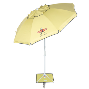 A yellow beach umbrella featuring a stick figure with a surfboard and the phrase \“Life is Good,\“ with a spiral anchor and base support.