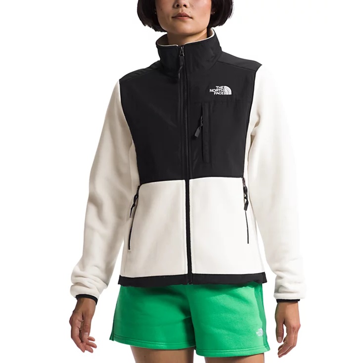 A two-tone fleece jacket with a high collar and front zip pockets paired with green shorts.