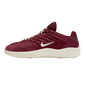 A maroon Nike sneaker with a white swoosh logo, featuring a textured upper and a thick white sole.