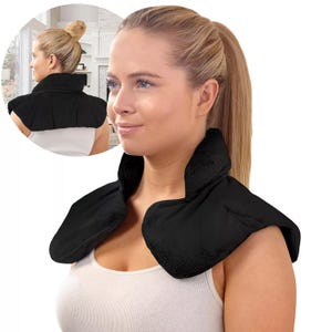 A woman wears a black heated neck and shoulder wrap designed for comfort and pain relief, featuring a high collar and extending over the shoulders.