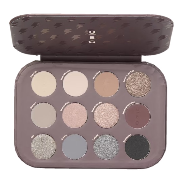 UBC eyeshadow palette with 12 shades featuring neutral and cool tones, including names like \“Cuddle Up,\“ \“Wrapped in a Blanket,\“ and \“Stormy Sky.\“