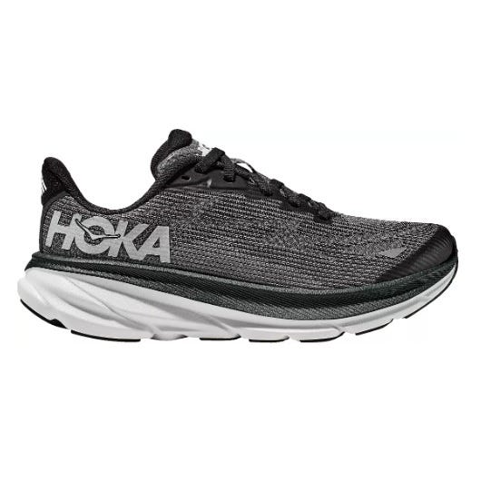 A black and white Hoka running shoe with a thick, cushioned sole featuring the brand's logo on the side.