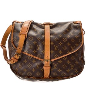 The Brown Monogram Canvas Saumur 35 is a Louis Vuitton shoulder bag featuring the brand's iconic monogram pattern, vachetta leather trim, and a crossbody strap. It has a saddlebag style with two compartments and buckle closures.