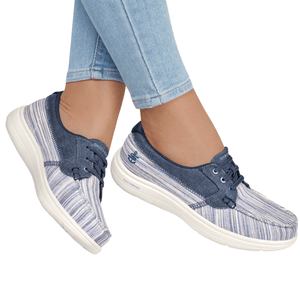 A pair of blue slip-on sneakers with white soles and a striped pattern, featuring the Skechers logo and Flex Comfort technology.