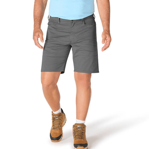 A person is wearing gray shorts, a light blue shirt, and brown hiking boots with white socks.
