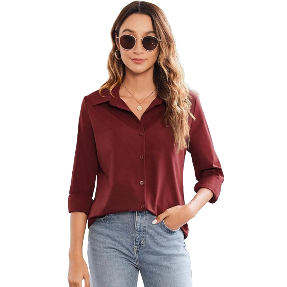 A woman is wearing a long-sleeve, maroon button-down blouse paired with light blue jeans. She accessorizes with round sunglasses, a necklace, and has her hair loose, styled with waves.