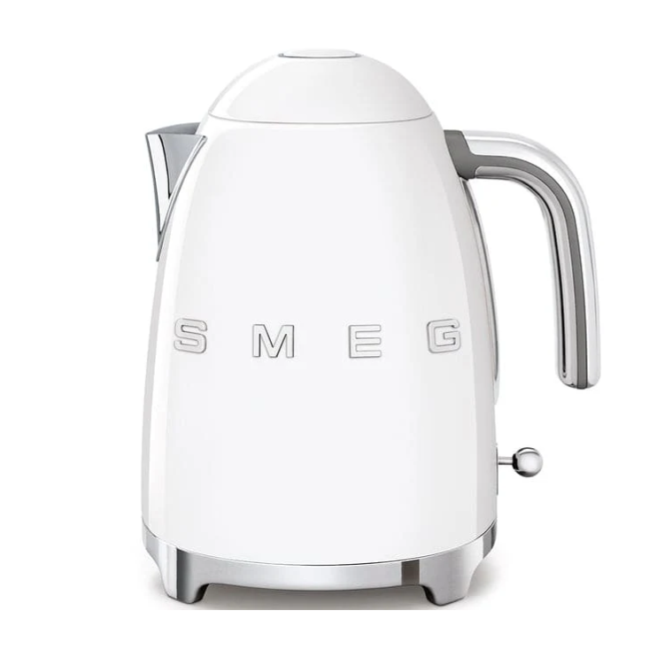 A white Smeg electric kettle with a retro design, featuring chrome accents and a prominent handle. The brand name \“SMEG\“ is displayed on the body.