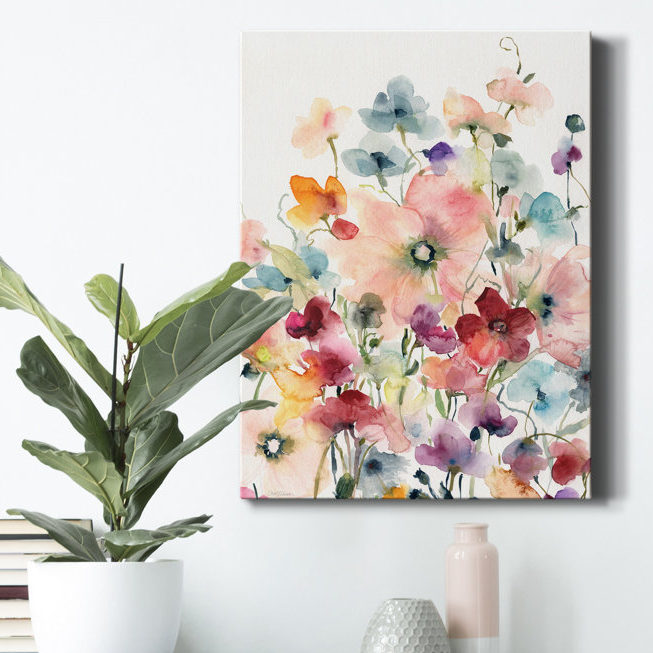 A vibrant watercolor canvas measuring 36\“x24\“ featuring poppies and sweetpeas in various colors such as pink, blue, orange, and purple. It's displayed on a wall beside a potted plant, books, and decorative vases.