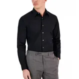 A man is wearing a black long-sleeve button-up shirt paired with gray dress pants.