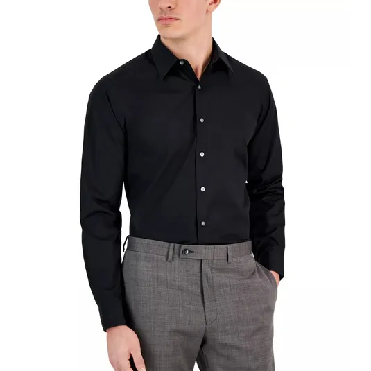 A man is wearing a black long-sleeve button-up shirt paired with gray dress pants.