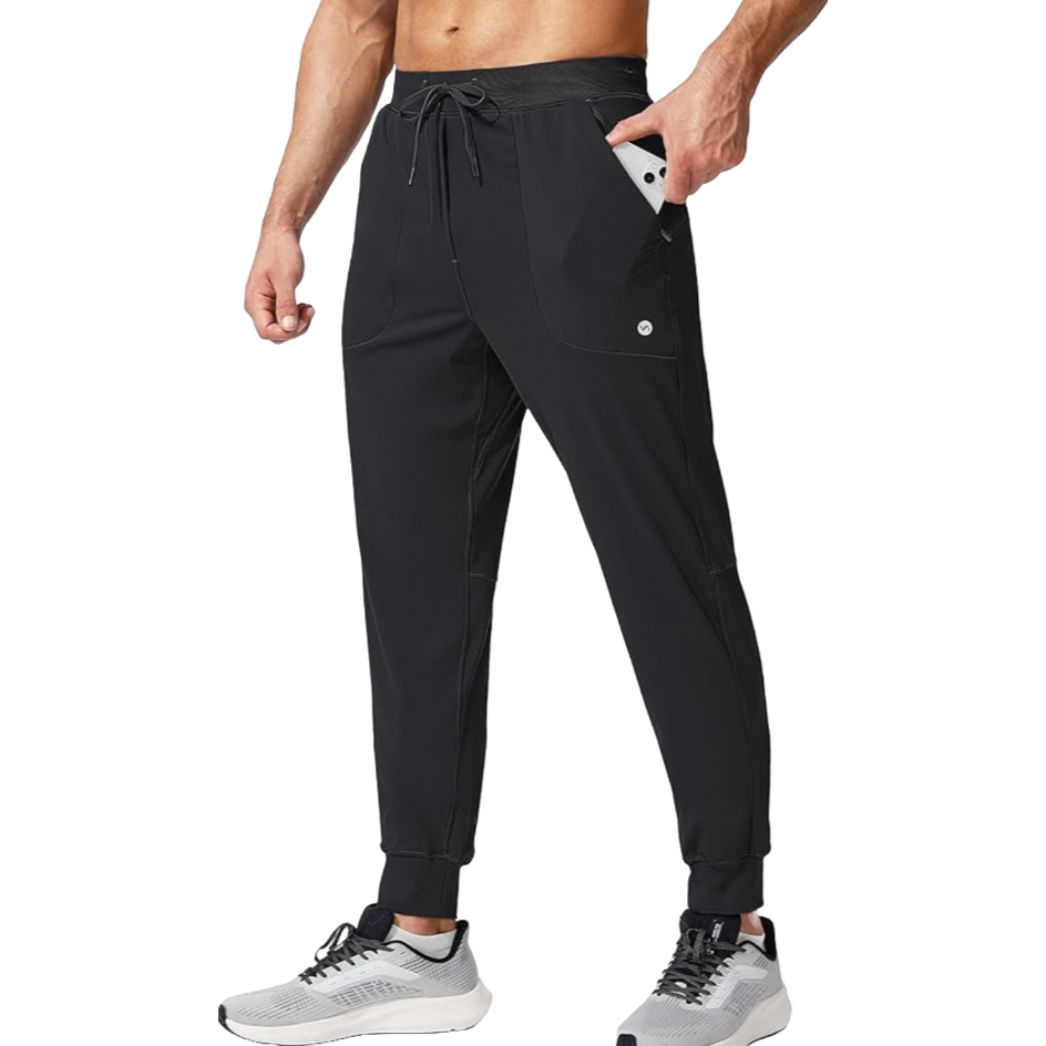 Men's black joggers with an elastic waistband and drawstring, featuring side pockets and a slim fit. The pants are paired with gray athletic shoes.