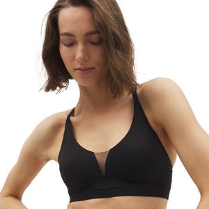 The Enbliss Racerback Bra features a black design with a deep V-neck and mesh insert. It provides support with a seamless look and racerback straps for comfort and flexibility.