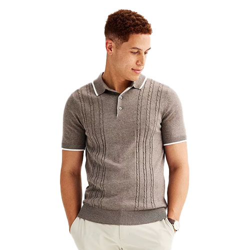 A short sleeve sweater polo shirt in gray featuring a cable-knit pattern on the front, with white trim on the collar and cuffs. The shirt has a button-up placket and is paired with light-colored pants.