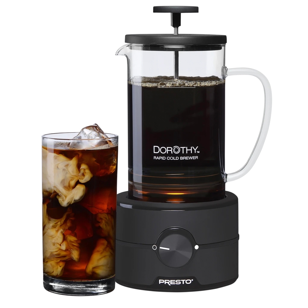 22oz Dorothy Rapid Cold Brewer with a clear glass carafe and a black handle, featuring a plunger lid. The unit rests on a black base with a dial, next to a glass of iced coffee.