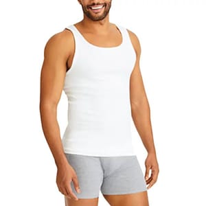 A man is wearing a white Hanes tank top, which is sleeveless with a scoop neckline. He is also wearing gray boxer briefs.