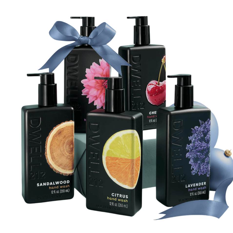 Dwell 212 hand wash bottles in black, featuring scents: Sandalwood, Citrus, Lavender, Cherry, and a floral variant. Each bottle is 12 fl. oz. (355 ml), with graphics representing their respective scents, adorned with decorative ribbons.
