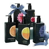 Dwell 212 hand wash bottles in black, featuring scents: Sandalwood, Citrus, Lavender, Cherry, and a floral variant. Each bottle is 12 fl. oz. (355 ml), with graphics representing their respective scents, adorned with decorative ribbons.