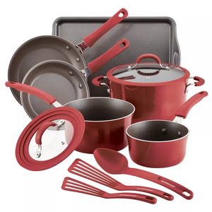 A red nonstick cookware set including pots, frying pans, saucepans with lids, a baking sheet, and three red cooking utensils.