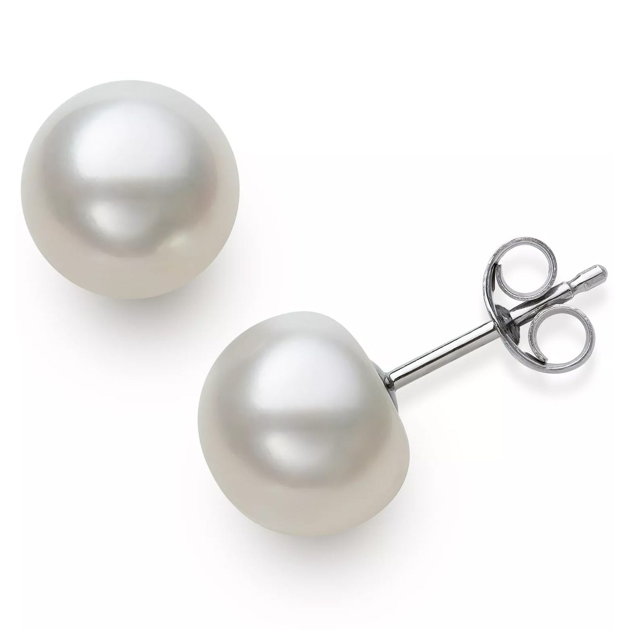 A pair of white pearl stud earrings with silver posts and butterfly backs.