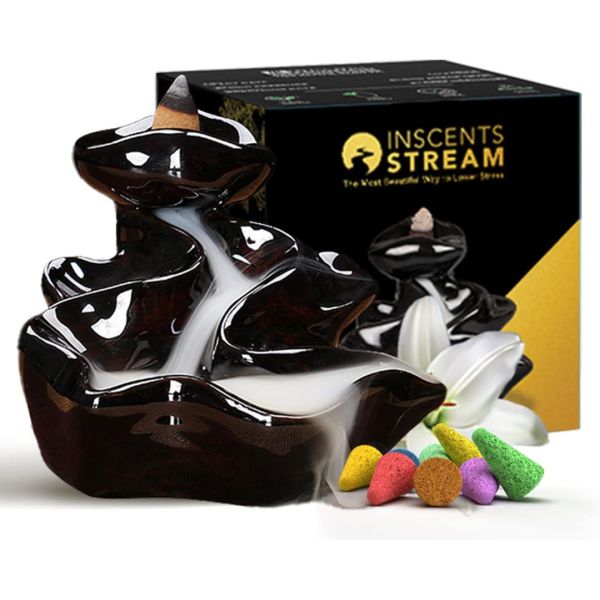 A backflow incense burner with a dark glossy finish is paired with colorful incense cones, alongside packaging labeled \“INSCENTS STREAM.\“