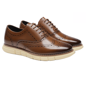 Brown Bruno Marc Wingtip Dress Sneakers feature brogue detailing with a polished finish and cream-colored rubber soles, combining classic style with modern comfort.