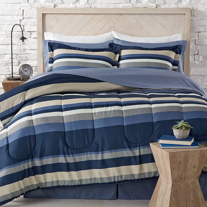 Striped bedding set with comforter, pillows, and sheets in blue and beige.