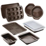 A set of non-stick bakeware featuring various pans, including muffin, loaf, round cake, and rectangular pans, along with a cooling rack and a cover for storage.