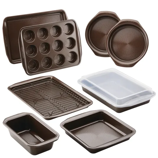 A set of non-stick bakeware featuring various pans, including muffin, loaf, round cake, and rectangular pans, along with a cooling rack and a cover for storage.