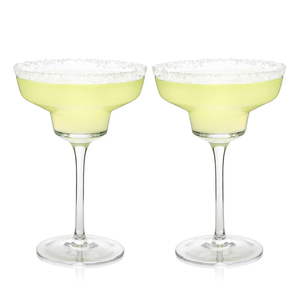 Two margarita glasses with salted rims containing a light green beverage.