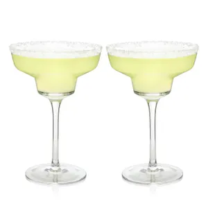 Two margarita glasses with salted rims containing a light green beverage.