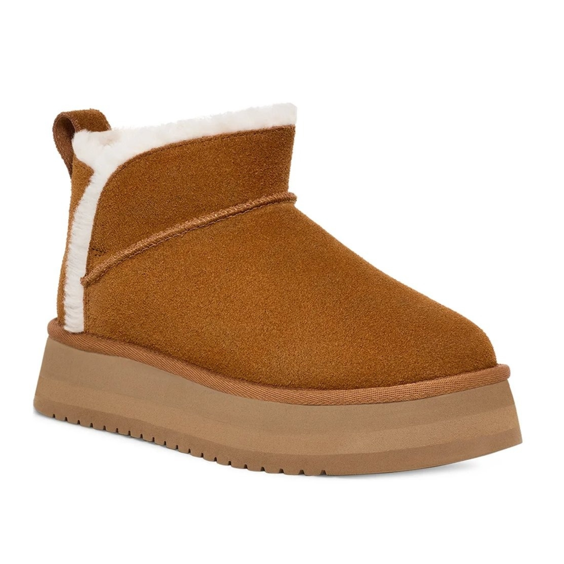 A brown suede boot with a thick platform sole and white shearling lining, featuring a pull tab at the back.