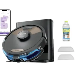 Shark robot vacuum with docking station, accompanied by a smartphone displaying a control app, bottle of cleaning solution, and additional accessories.