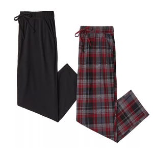 Two pairs of pajama pants with drawstring waists: one solid black and the other in a red, gray, and black plaid pattern.
