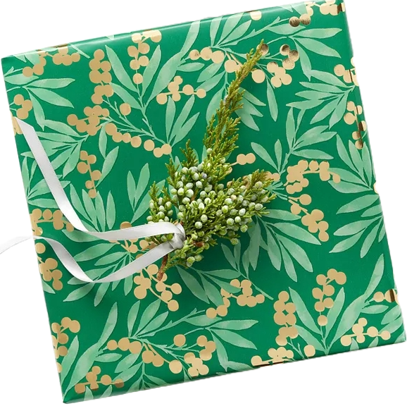 Green wrapping paper with a pattern of gold berries and light green leaves, featuring a white ribbon and a small sprig of greenery attached.
