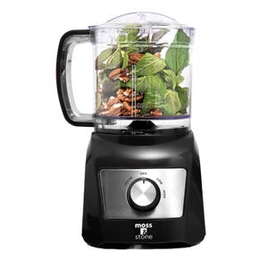 Moss & Stone 3-Cup Mini Food Processor, black base with controls for pulse, low, and high settings. The transparent container holds leafy greens and nuts.