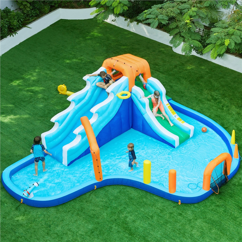 The 20' x 15' inflatable water slide set features dual blue and white slides with an orange arch, a splash pool, climbing wall, basketball hoop, and spray cannons, set on green artificial grass.