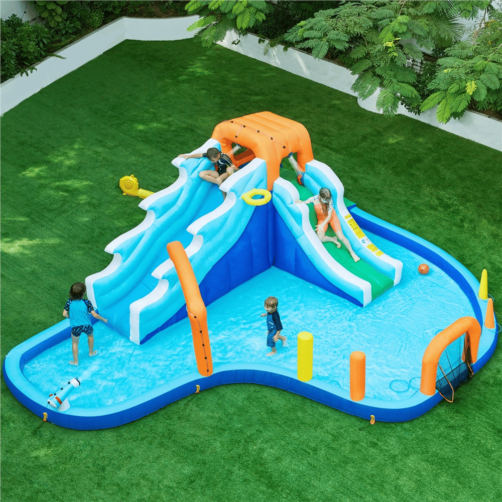 The 20' x 15' inflatable water slide set features dual blue and white slides with an orange arch, a splash pool, climbing wall, basketball hoop, and spray cannons, set on green artificial grass.