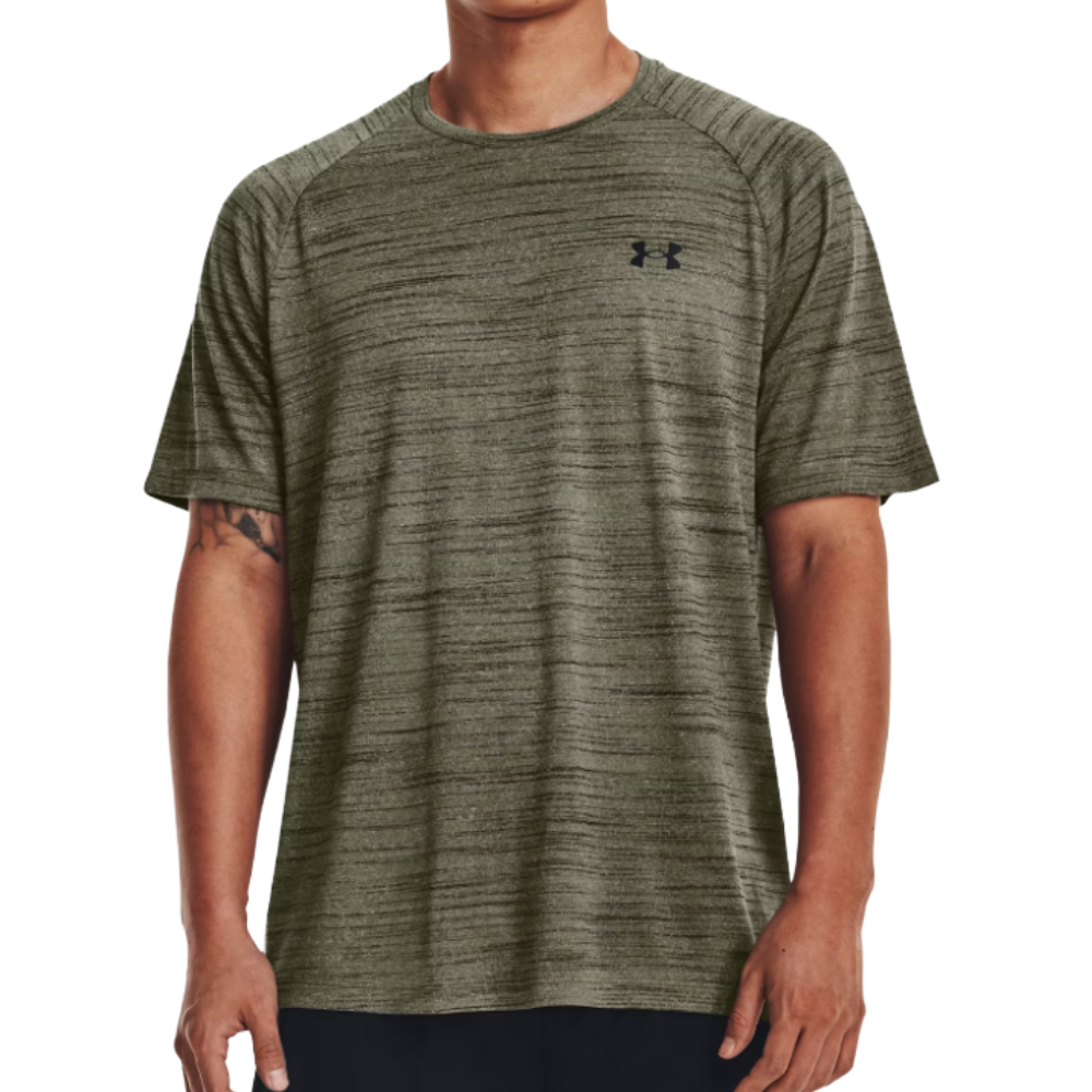A man wears an olive green Under Armour short-sleeve performance t-shirt with a subtle heathered texture and a small logo on the chest.