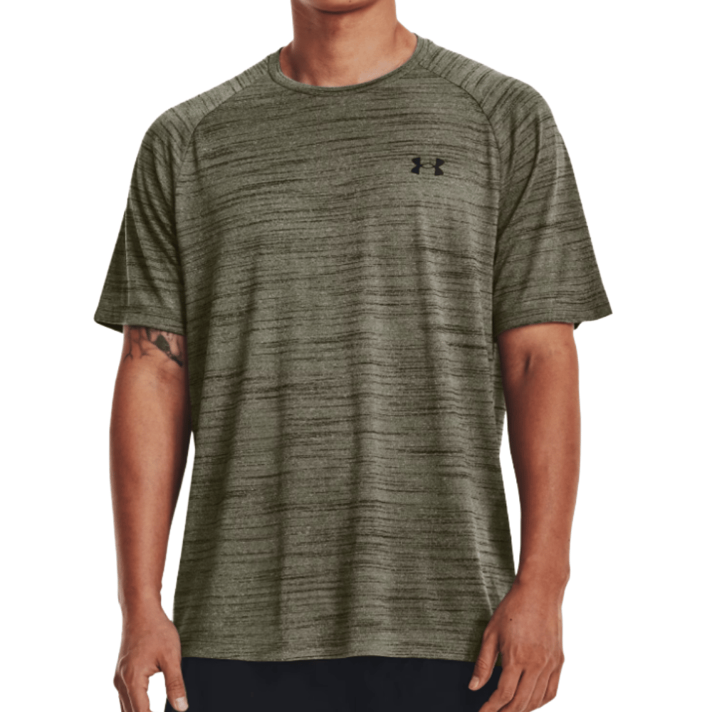 A man wears an olive green Under Armour short-sleeve performance t-shirt with a subtle heathered texture and a small logo on the chest.
