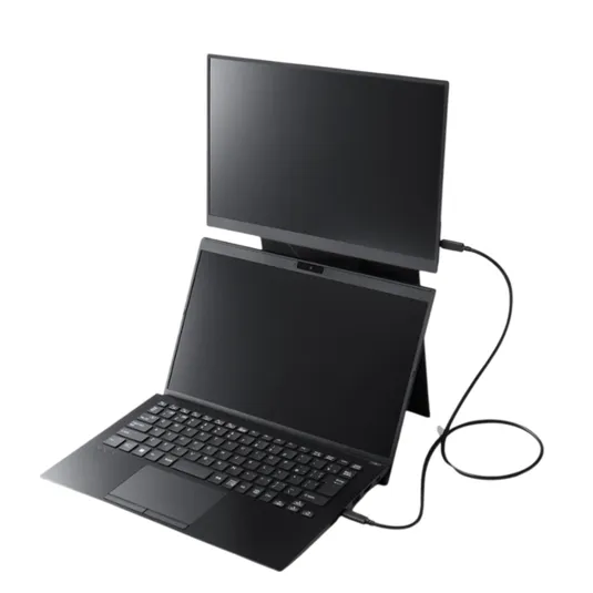 A compact, dual-screen laptop setup with an external monitor connected via a cable, positioned above the laptop.