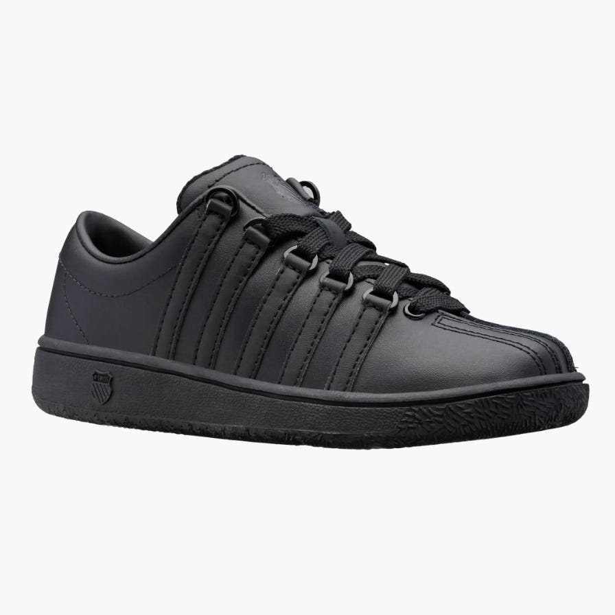 A single black sneaker with laces and a low-top design.