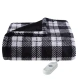 A black and white plaid electric blanket with a remote control.