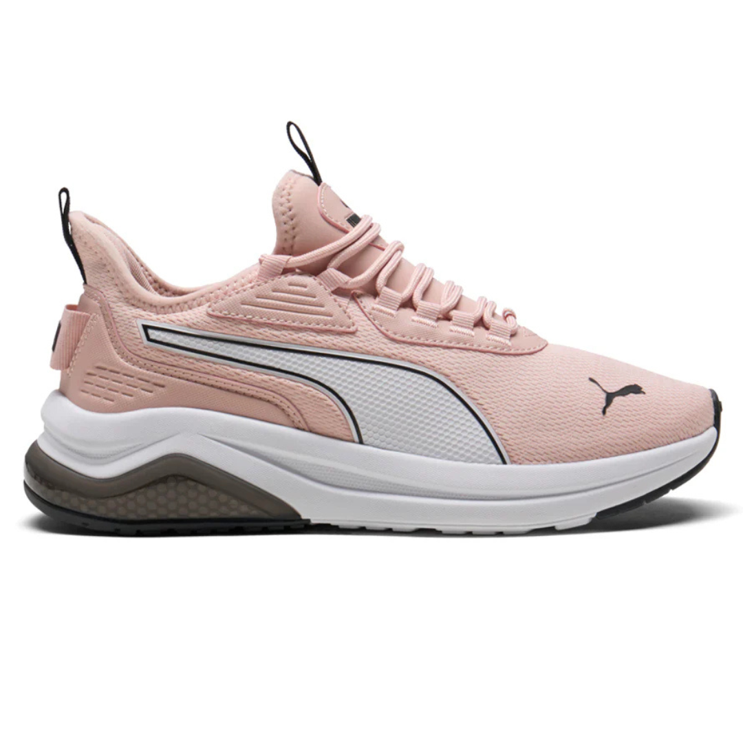 Puma Amplifier Sneakers in light pink feature a mesh upper with a white midsole and black rubber outsole. The design includes a signature Puma logo on the side and toe, and a pull tab at the heel for easy wearing.