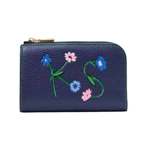 Navy leather compact wallet featuring floral embellishments forming \“KS,\“ with a zip closure and textured finish.