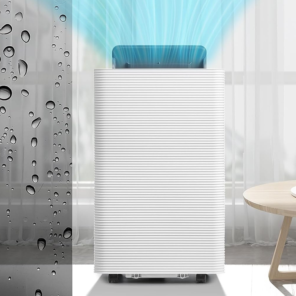 White air purifier with blue air outlet on top, placed near a coffee table.