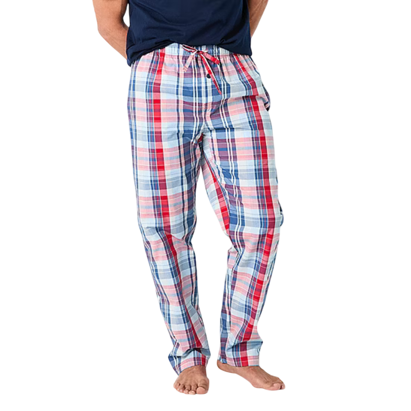 Plaid pajama pants in red, blue, and white with a drawstring waist, worn by a person barefoot.