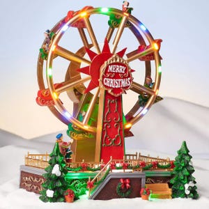 The St. Nicholas Square Holiday Ferris Wheel is a festive decoration featuring a rotating Ferris wheel with colorful lights and \“Merry Christmas\“ signage, set on a snowy base with small figures and Christmas trees, adding a seasonal touch to holiday decor.
