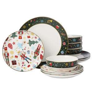 Festive dinnerware set with holiday-themed designs featuring nutcrackers, a ballerina, and gift motifs on plates and bowls.