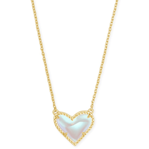 A gold chain necklace featuring a heart-shaped pendant with an iridescent stone, bordered by a gold frame. The design is simple and elegant.