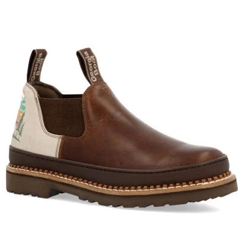 A brown leather slip-on boot with a decorative pull tab and side elastic panels, featuring a contrasting back panel with a nature scene design.
